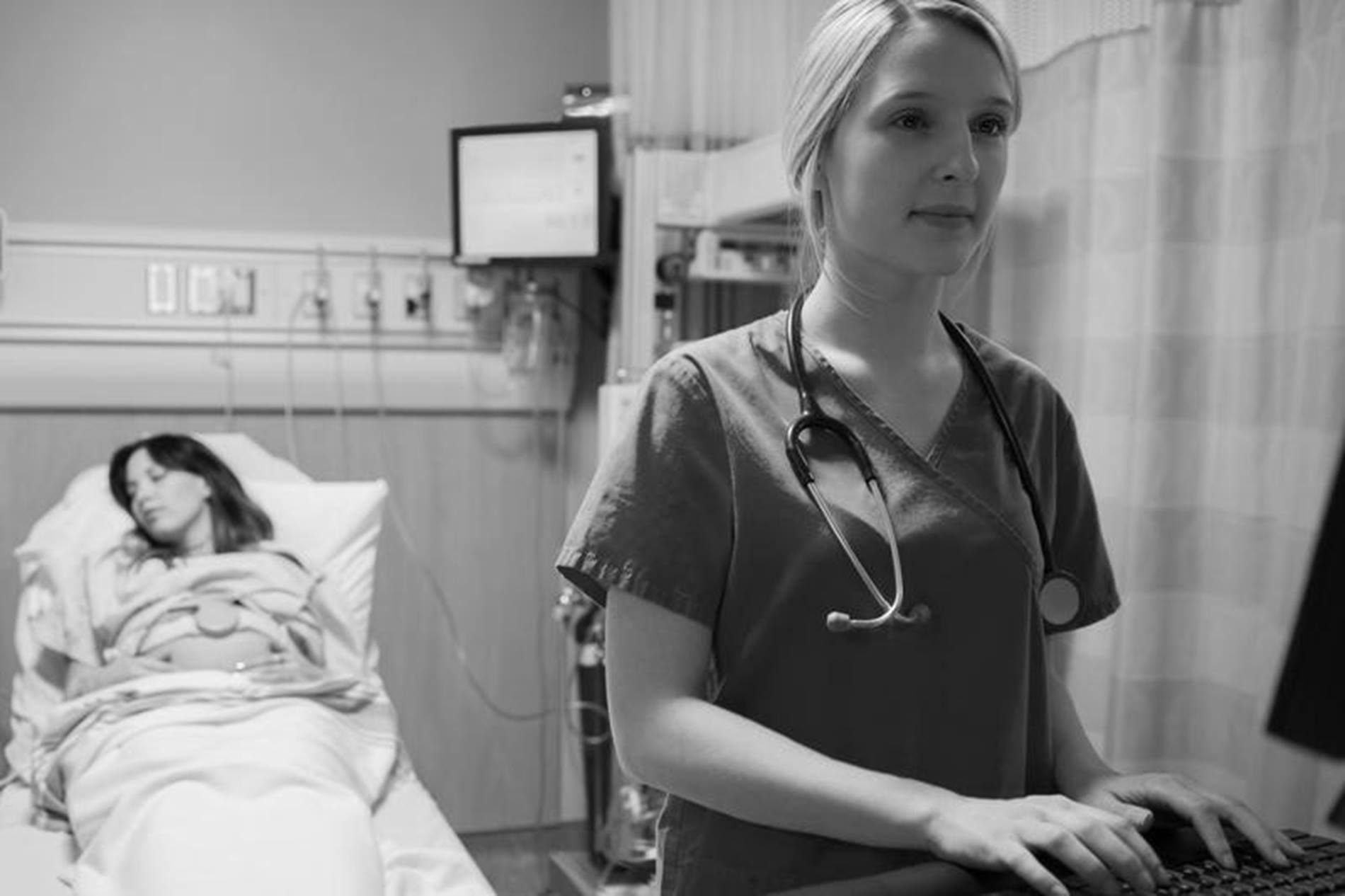 Hospital staff using computer in black and white