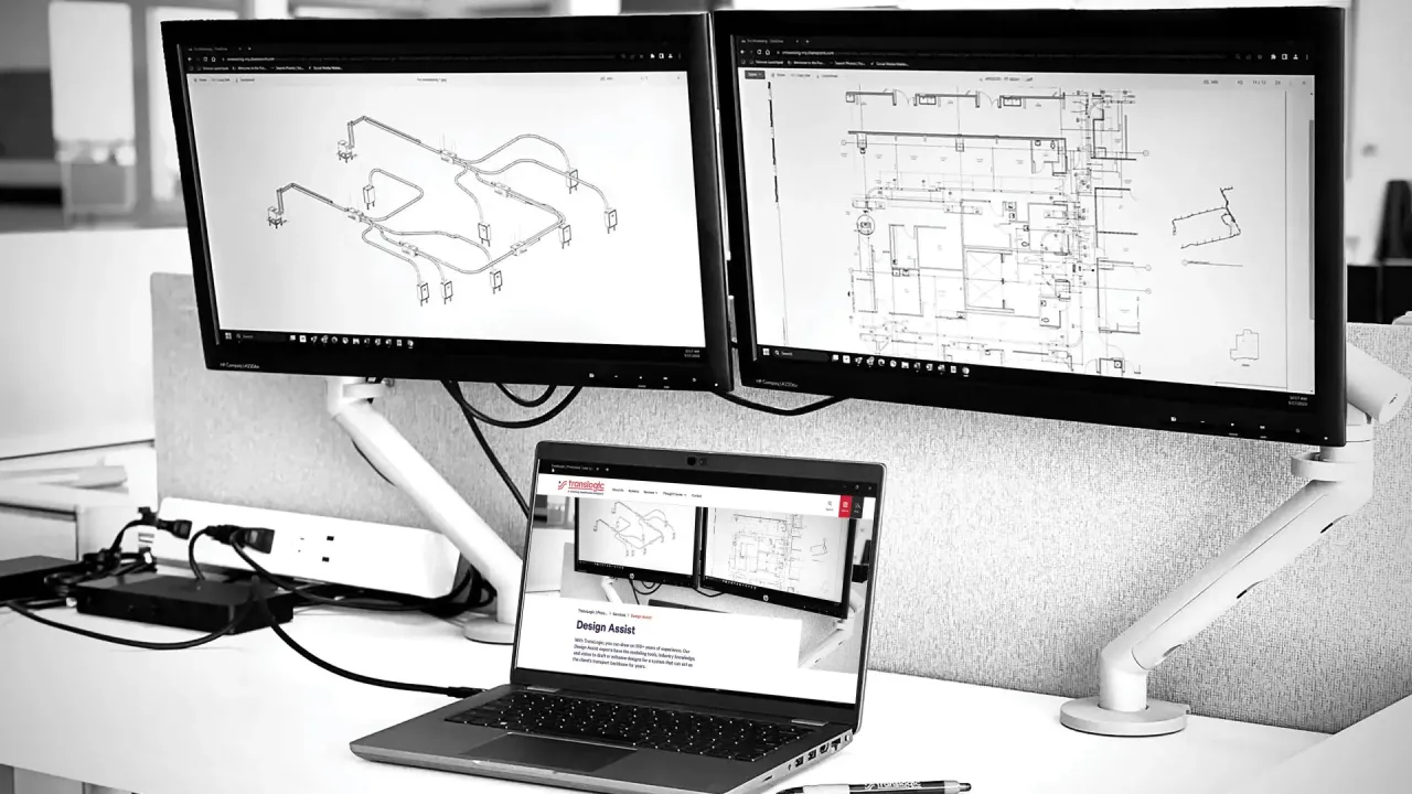 two computers showing bim 3d model and design plans