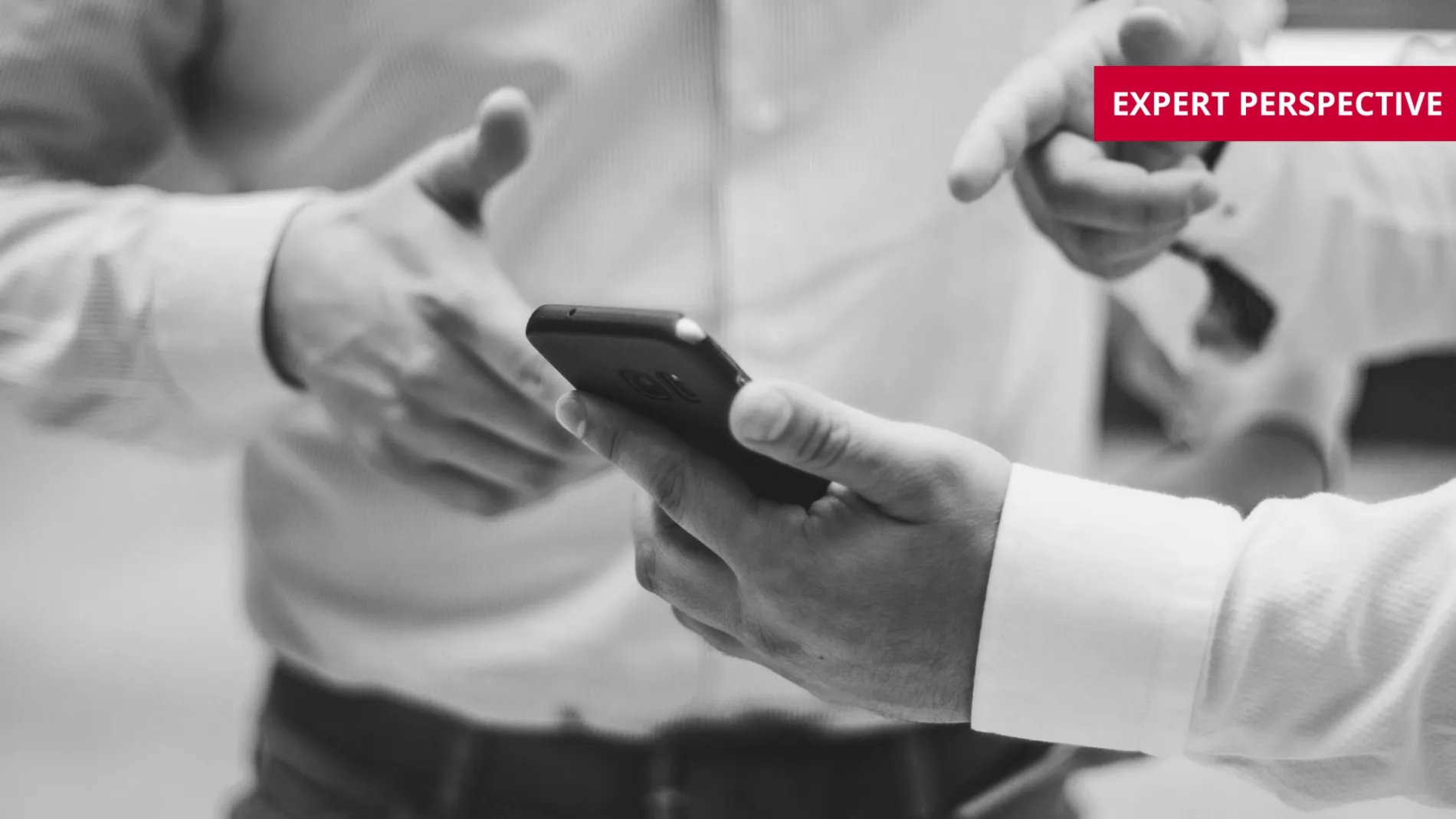 two people looking at a mobile phone