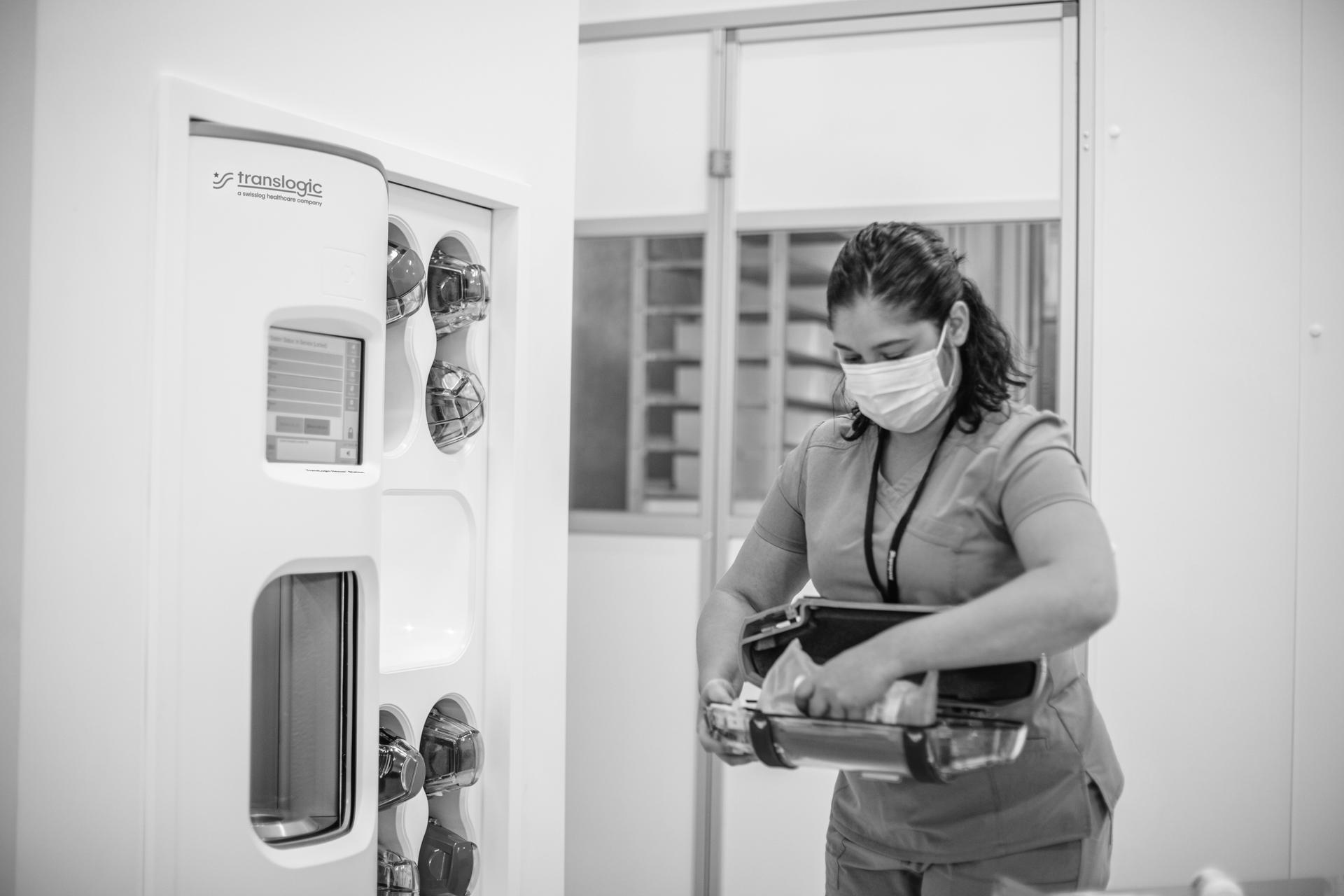 staff loading carrier into tube system station