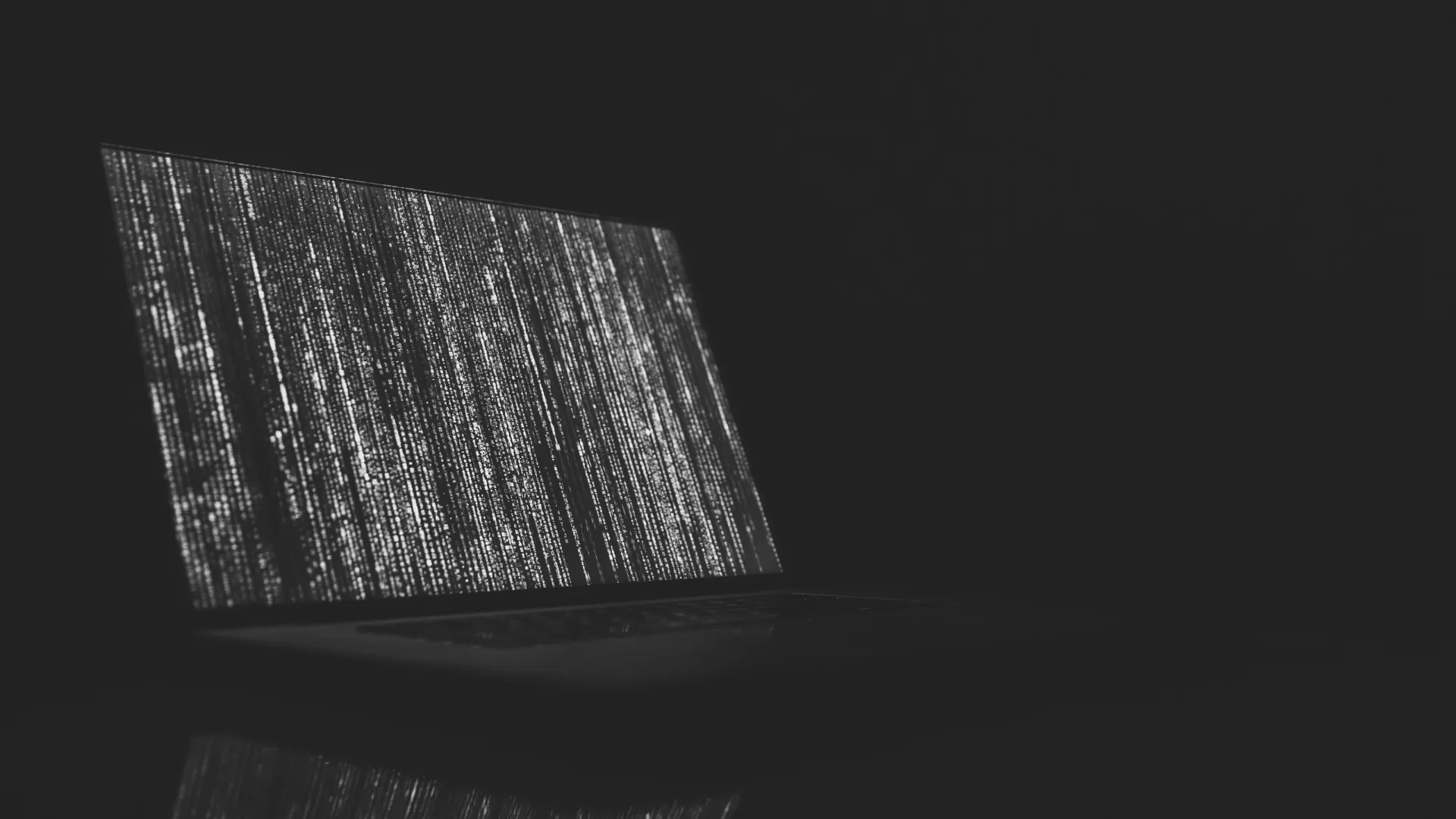 computer on desk running code