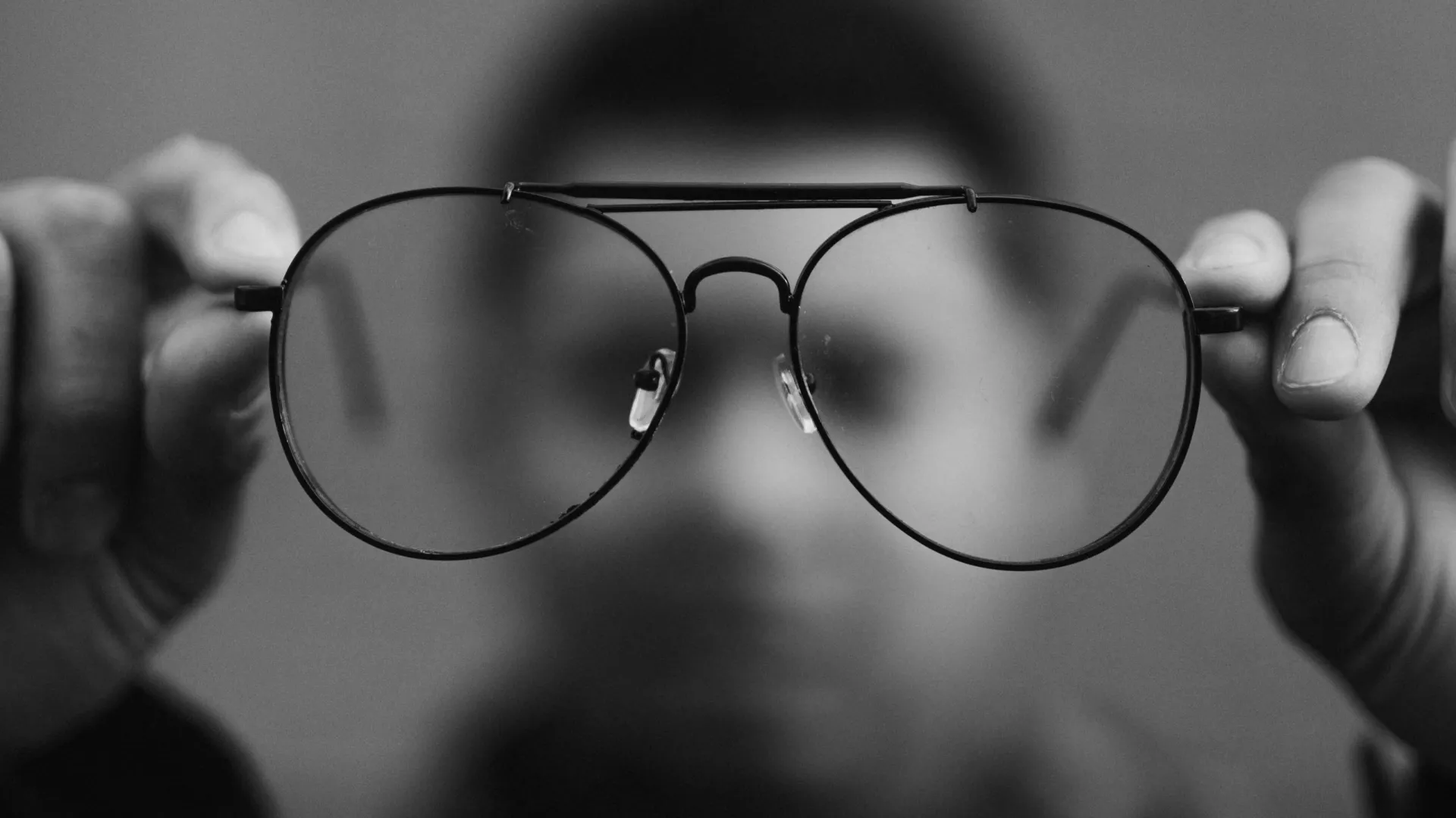 man holding glasses