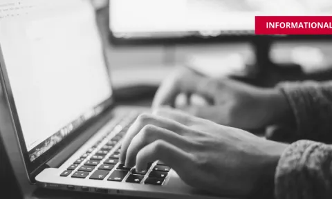 hands typing rfp at computer